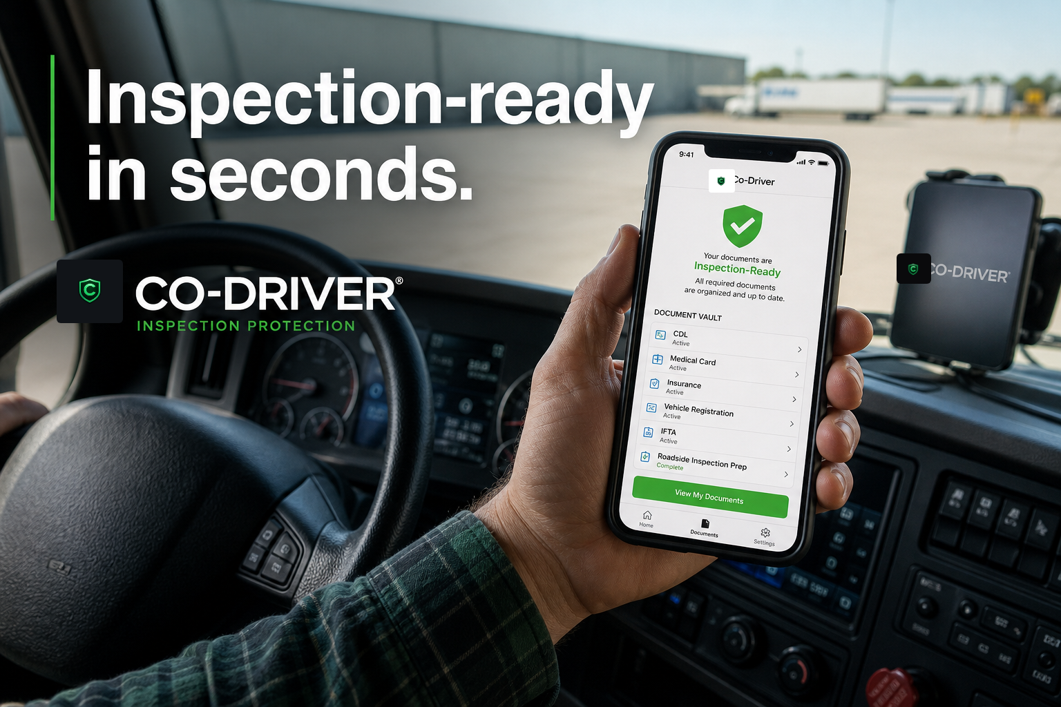 Driver holding a phone showing Co-Driver's Document Vault marked Inspection-Ready, dash-mounted phone and steering wheel visible — 'Inspection-ready in seconds.'